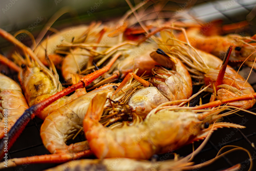 The grilled shrimp on the stove are about to be ready to eat. The grilled shrimp on the stove are about to be ready to eat.