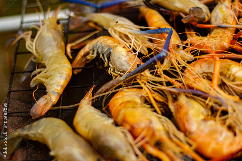 The grilled shrimp on the stove are about to be ready to eat. The grilled shrimp on the stove are about to be ready to eat.