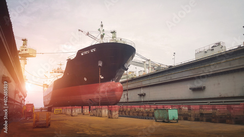 Canvas Print Shipyard ship moored in floating dock on boat sleepers under ship Maintenance with sunset, Front View of Vessel repair on sepia tone
