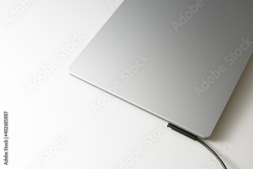 Close-up top view of laptop in platinum silver color on white background