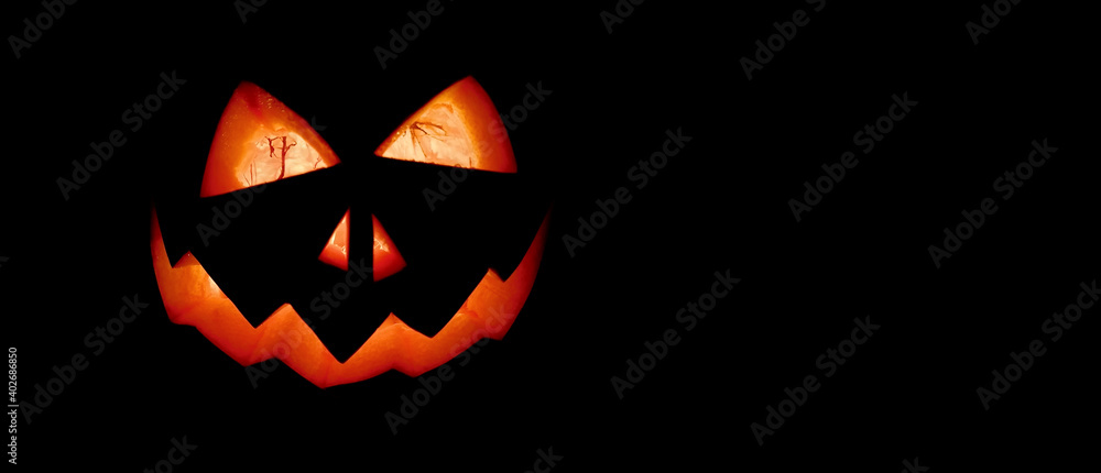 Halloween carved pumpkin with spooky face on a black background stock images. Grinning pumpkin photo images. Scary halloween pumpkin with creepy face on a black background with copy space for text Halloween carved pumpkin with spooky face on a black background stock images. Grinning pumpkin photo images. Scary halloween pumpkin with creepy face on a black background with copy space for text