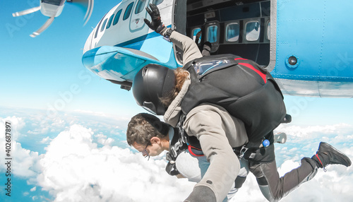 Tandem skydivers jumping from plane