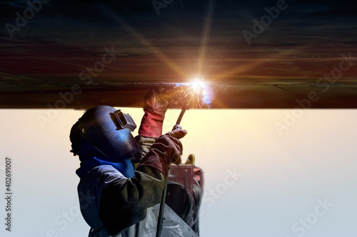 Fotobehang Worker welding position overhead under ballast tank under ship repair in floatin