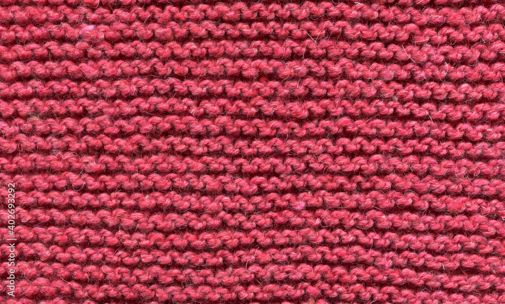 texture of a knitted red fabric with a simple pattern, horizontal rows