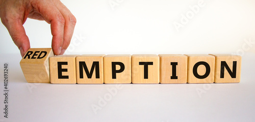 Redemption or emption symbol. Male hand turns a wooden cube and changes the word 'emption' to 'redemption'. Beautiful white background, copy space. Business and redemption concept. photo