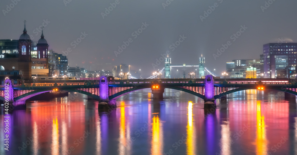 Panoramic view over the famous historical London Bridge, River Thames and the Towers of London, illuminated at night