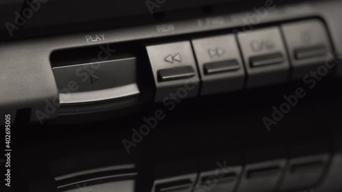 Wallpaper Mural Play button on an old black audio cassette player. The man presses the play button with his finger. Close-up buttons. Old technologies of the previous generation. Analog equipment Torontodigital.ca