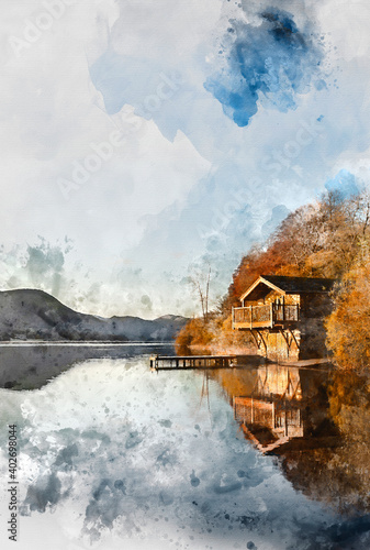 Epic vibrant sunrise Autumn Fall landscape image of Ullswater in Lake District with golden sunlight photo