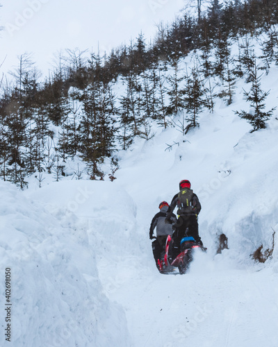 Having fun and riding on snowmobiles in polish mountains