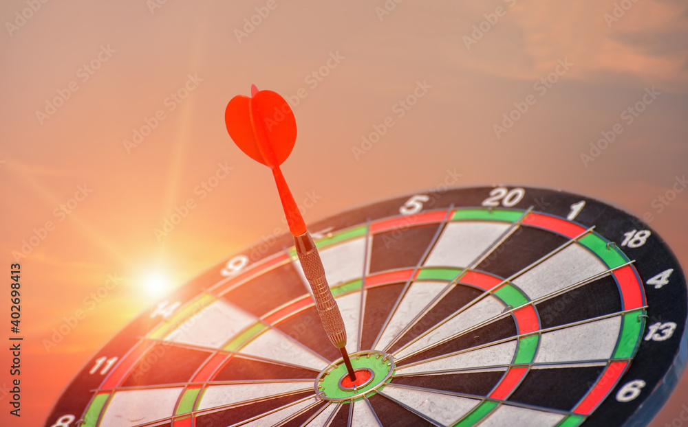 Arrow hit the target with light on sunset background, the game focuses on success, planning to be smart concept. Arrow hit the target with light on sunset background, the game focuses on success, planning to be smart concept.
