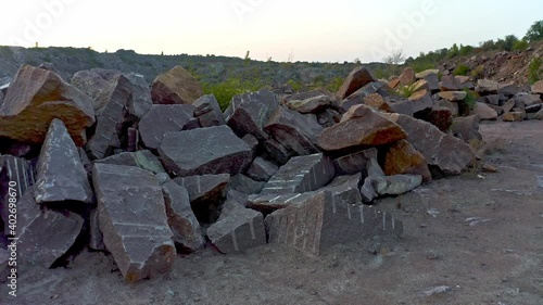 A large number of boulders in the warm evening light lie in huge heaps on dry terrain in the ryan shakty. Aerial UHD 4K drone realtime video, shot in 10bit HLG and colorized photo