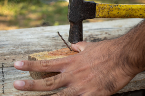 Accident of hammering a nail when hammer hammering a carpenter's finger.