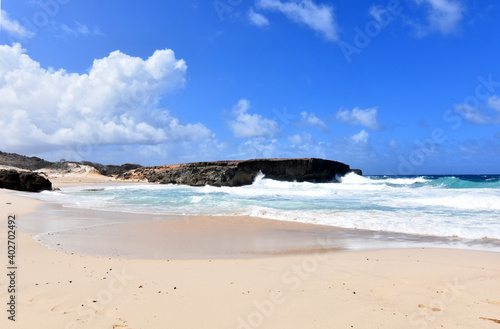 Scenic Remote Beach with Waves Rolling Ashore in Aruba photo