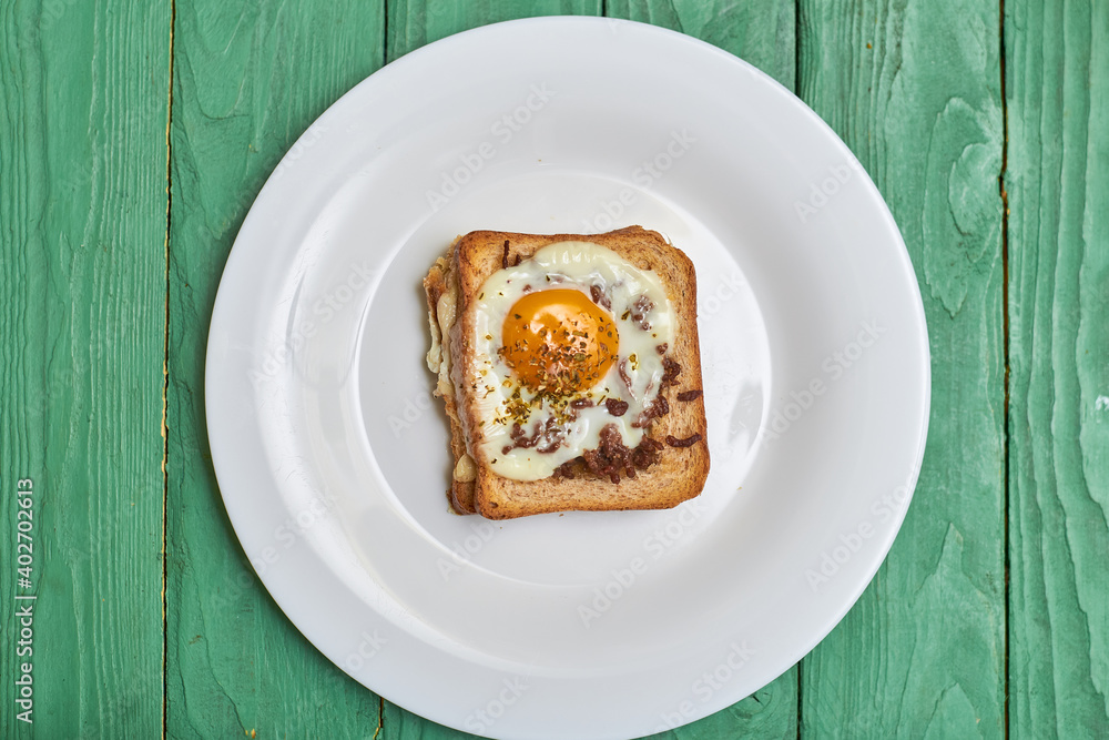 Sandwich on toast with minced meat, egg and seasonings. Sandwich on toast with minced meat, egg and seasonings.