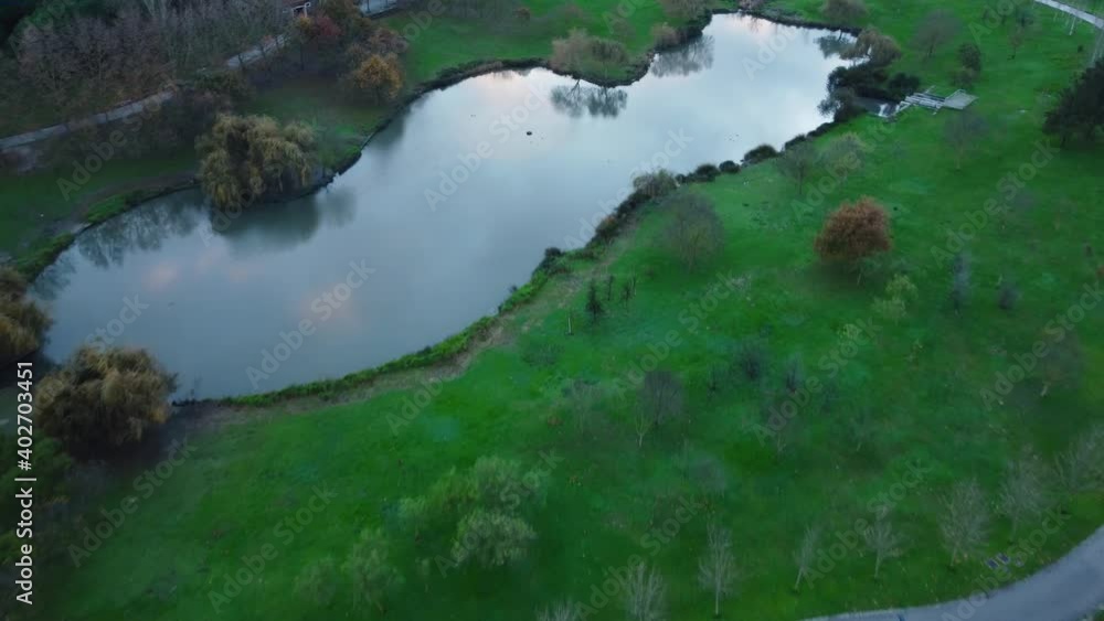 Drone Aerial View of Lake at Parque da Paz, Almada, Portugal with birds flying Drone Aerial View of Lake at Parque da Paz, Almada, Portugal with birds flying