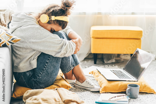 Bored woman sitting near laptop. Concept of quarantine for coronavirus working from home.