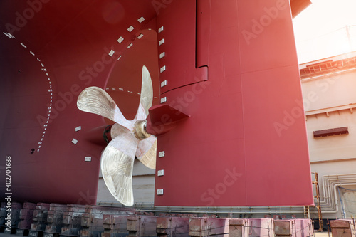 Φωτογραφία Close up Big Propeller and rudder at stern of big ship during maintenance at flo