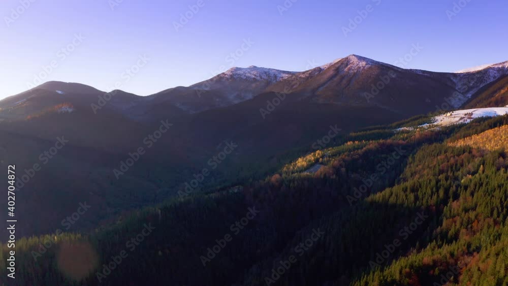 Picturesque mountain landscapes of autumn with snow near the village of Dzembronya in Ukraine Carpathians mountains. Aerial UHD 4K drone realtime video, shot in 10bit HLG and colorized Picturesque mountain landscapes of autumn with snow near the village of Dzembronya in Ukraine Carpathians mountains. Aerial UHD 4K drone realtime video, shot in 10bit HLG and colorized
