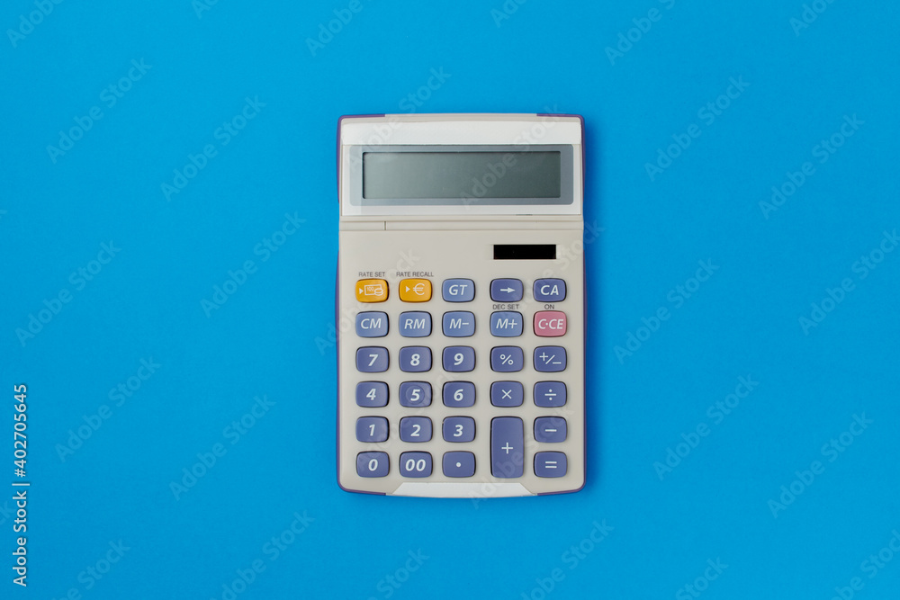 flat lay with calculator on blue flat lay with calculator on blue