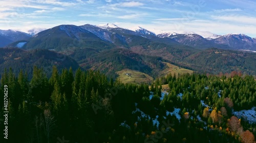 Small village in a mountain valley of the Carpathian Mountains on an autumn day in Ukraine in the village of Dzembronya. Aerial UHD 4K drone realtime video, shot in 10bit HLG and colorized photo