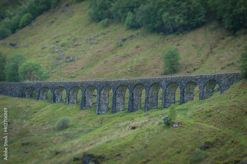 Tilt shift effect of stone railway bridge near Crianlarich, Scotland. Concept: Scottish railways, mysterious ancient places, Scottish nature