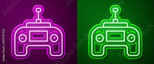 Glowing neon line Drone radio remote control transmitter icon isolated on purple and green background. Vector.