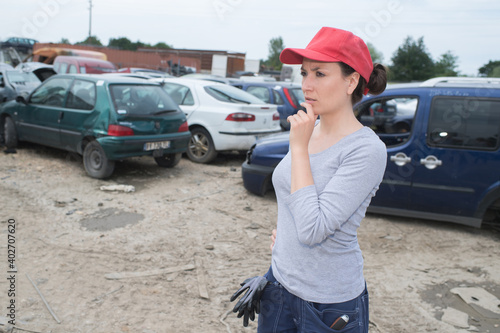 female mechanic in scrap yard © auremar