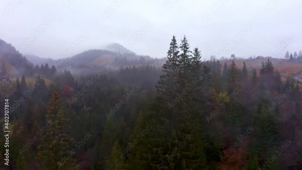 Rainy foggy and gray weather in the mountain valley of the Carpathians in Ukraine in small village Dzembronya. Aerial UHD 4K drone realtime video, shot in 10bit HLG and colorized Rainy foggy and gray weather in the mountain valley of the Carpathians in Ukraine in small village Dzembronya. Aerial UHD 4K drone realtime video, shot in 10bit HLG and colorized