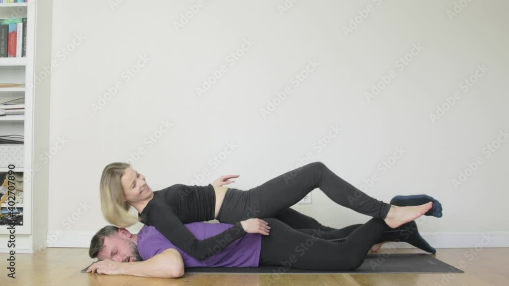 A man doing pushups with his bored girlfriend lying on top of him with a workout fail as they collapse and fall down together. A man doing pushups with his bored girlfriend lying on top of him with a workout fail as they collapse and fall down together.