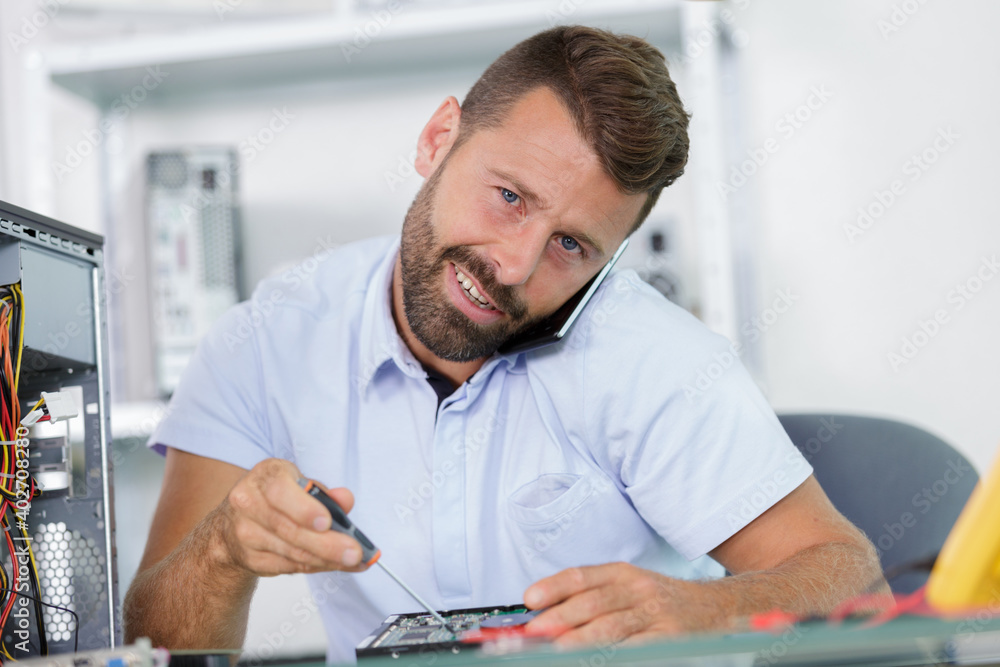 a disassembled man fixing a hard drive