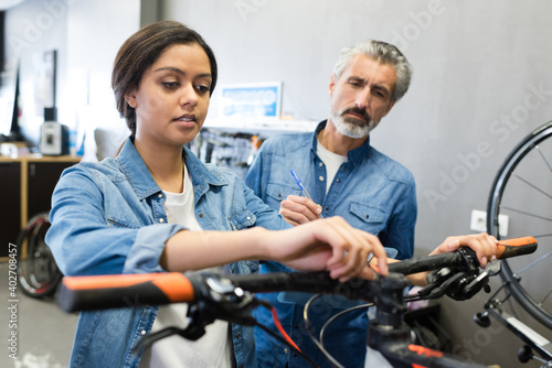 involved woman repairing the bicycle in the garage