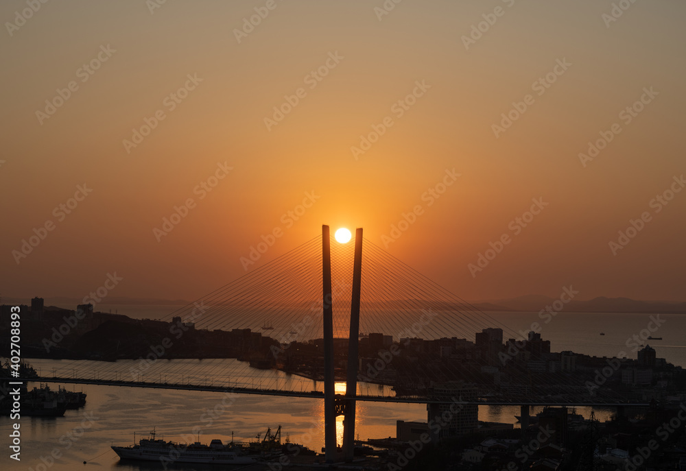 Naklejka premium Vladivostok cityscape - sunset over bridge.
