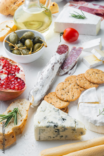 Italian snacks, meat cheese, herbs, on white background