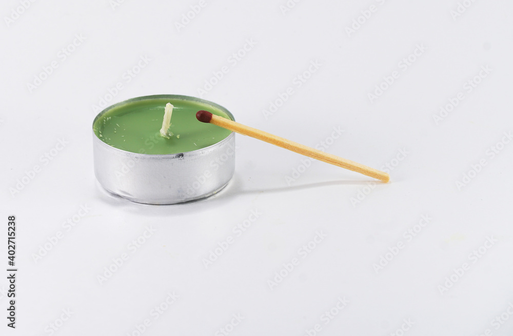 unlit colored candle with unlit match on white background unlit colored candle with unlit match on white background