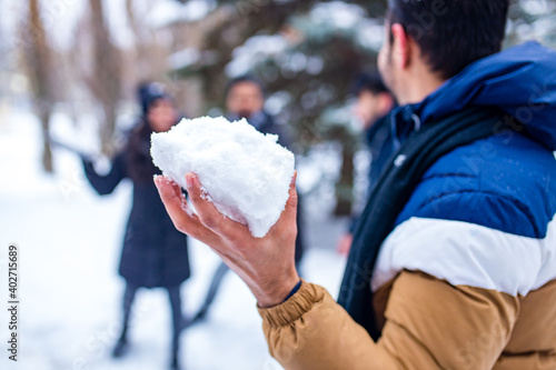 group of four indian having fun playing in snow outdoors spending Chrisymas holidays photo