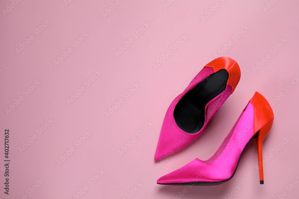 Pair of beautiful shoes on pink background, top view. Space for text Pair of beautiful shoes on pink background, top view. Space for text