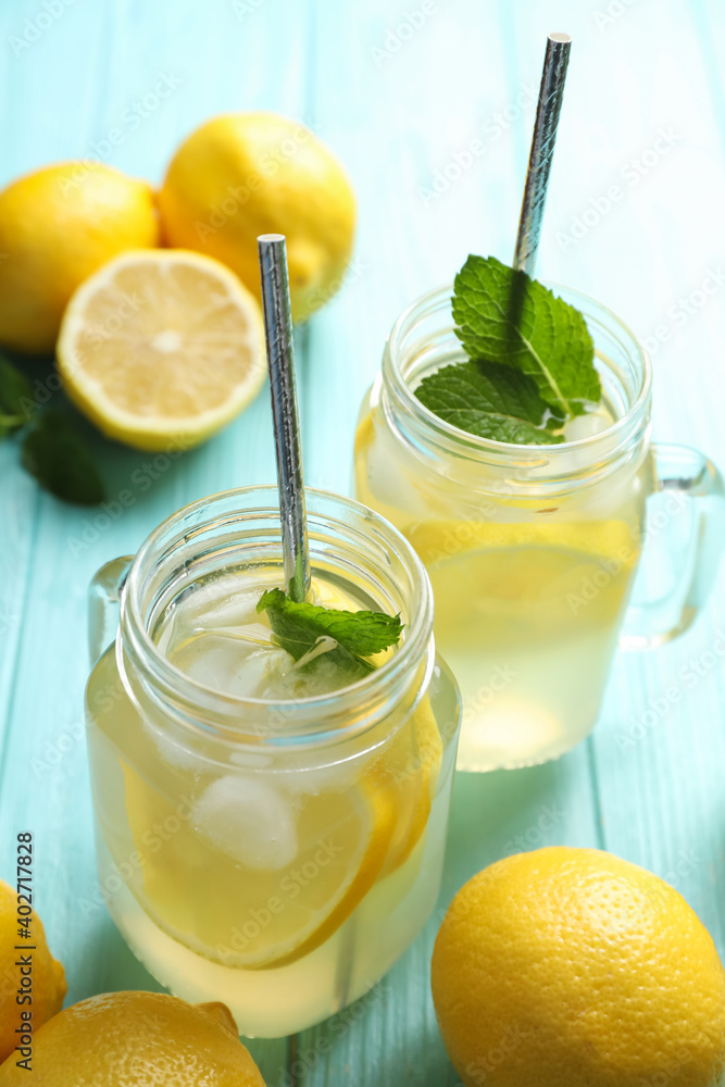 Natural lemonade with mint on light blue wooden table. Summer refreshing drink Natural lemonade with mint on light blue wooden table. Summer refreshing drink
