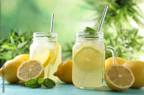 Natural lemonade with mint on light blue wooden table. Summer refreshing drink