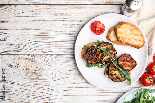 Delicious eggplant sandwiches served on white wooden table, flat lay. Space for text