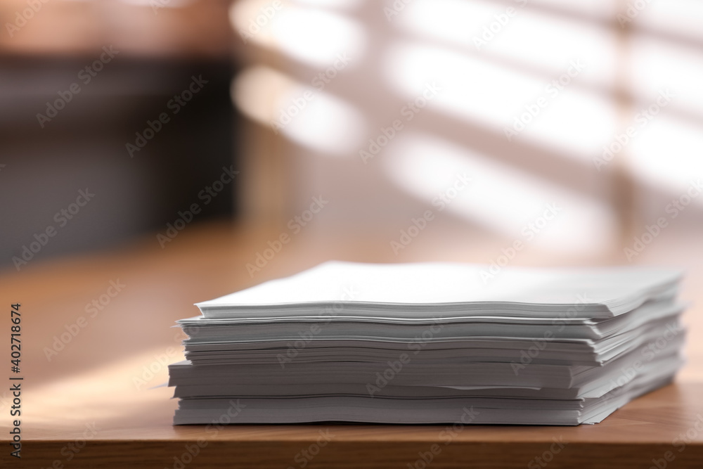 Stack of blank paper on wooden table indoors. Space for text Stack of blank paper on wooden table indoors. Space for text