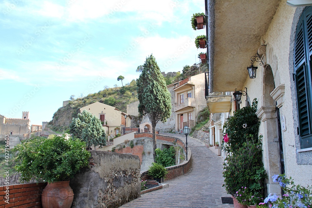 path, sidewalk between houses, on a hill in a small mountain town in Sicily, Savoca, Italy