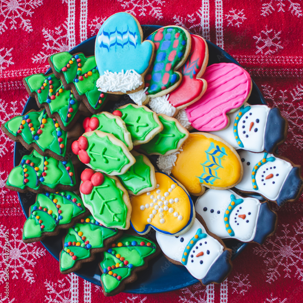 A platter of beautifully decorated bright colorful Christmas cookies