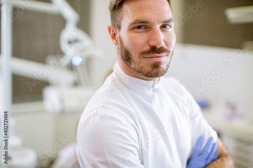 Handsome dentist posing in ...