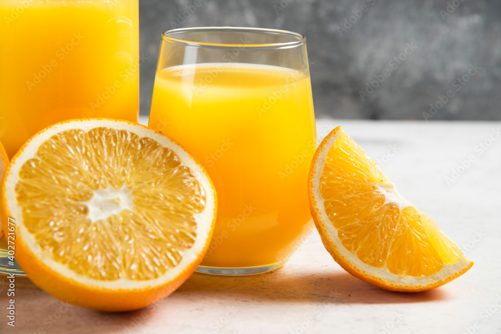 A glass cup of fresh juice with sliced orange A glass cup of fresh juice with sliced orange