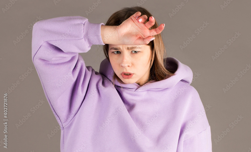 Beautiful woman tired at work, isolated on a gray background Beautiful woman tired at work, isolated on a gray background