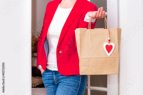 Shopping red heart bag Valentine's Day hand holding delivery door