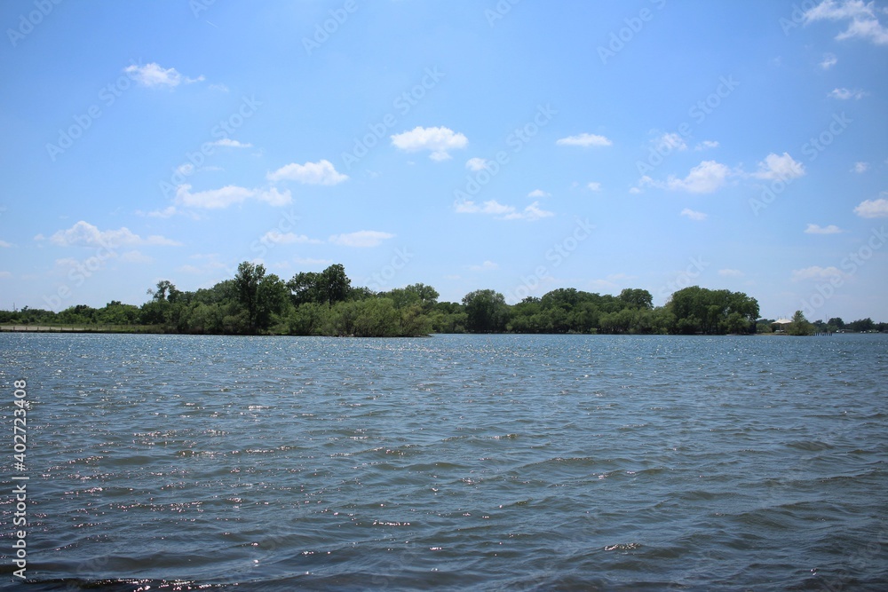 River With Greenery In the Distance on with a Blue Sky River With Greenery In the Distance on with a Blue Sky