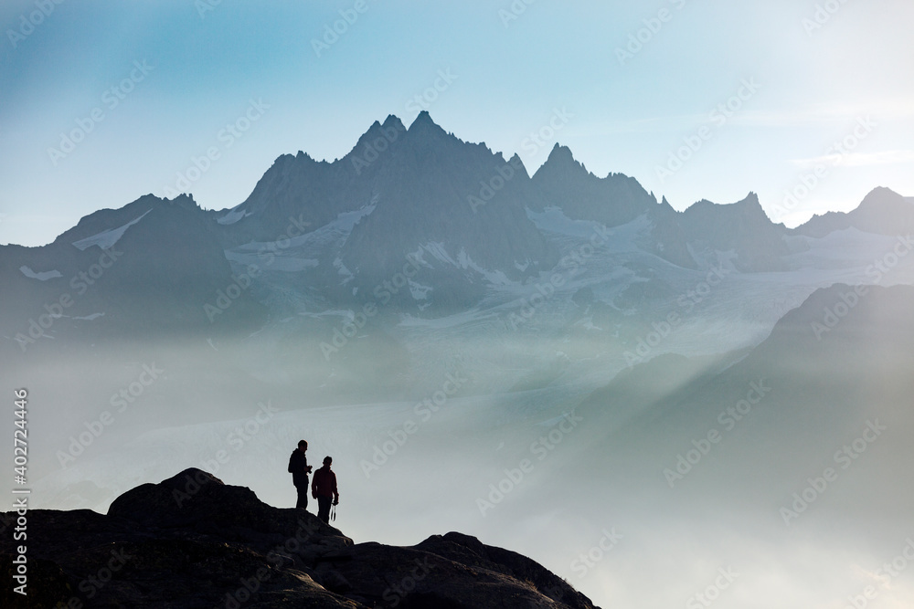 Profiles of two people photographers in the French Alps against the backdrop of the Mont Blanc massif, Chamonix