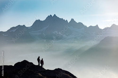 Profiles of two people photographers in the French Alps against the backdrop of the Mont Blanc massif, Chamonix