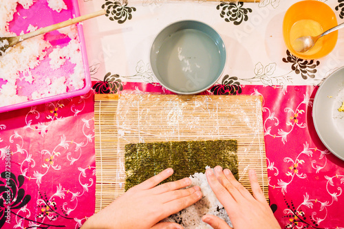 Concept cooking at home. Hands cooking sushi at home.